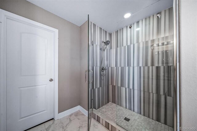 7720 S Queensburg Way, Aurora, CO 80016 - bathroom with marble look tile flooring, a shower stall, baseboards, and recessed lighting