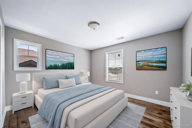 7720 S Queensburg Way, Aurora, CO 80016 - bedroom featuring multiple windows, baseboards, and dark wood-type flooring