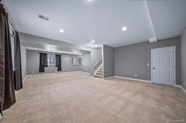 7720 S Queensburg Way, Aurora, CO 80016 - below grade area with light colored carpet, stairway, baseboards, and recessed lighting