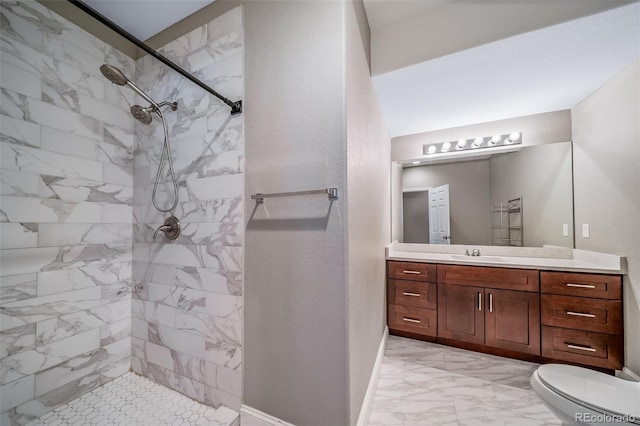 7720 S Queensburg Way, Aurora, CO 80016 - bathroom featuring marble finish flooring, toilet, tiled shower, vanity, and baseboards