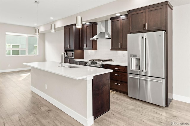 1615 Harlan St Unit 2, Lakewood, CO 80214 - kitchen featuring appliances with stainless steel finishes, wall chimney range hood, a sink, baseboards, and recessed lighting