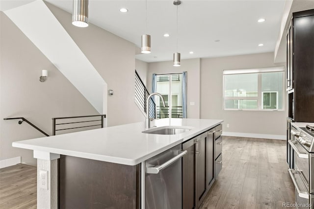 1615 Harlan St Unit 2, Lakewood, CO 80214 - kitchen featuring a sink, stainless steel appliances, light wood finished floors, light countertops, and recessed lighting