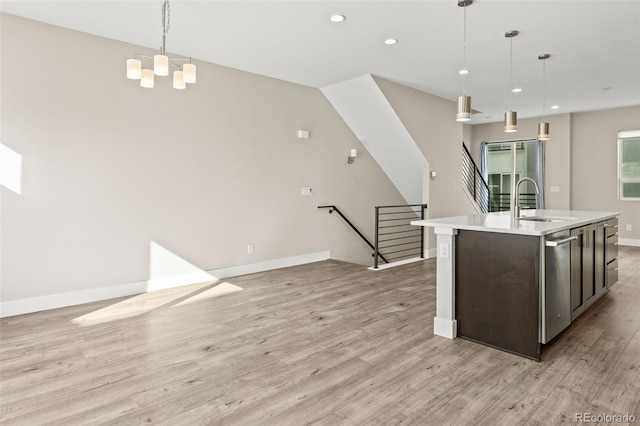 1615 Harlan St Unit 2, Lakewood, CO 80214 - kitchen featuring a sink, light wood-style flooring, dishwasher, an island with sink, and light countertops
