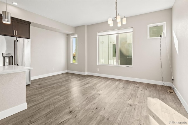 1615 Harlan St Unit 2, Lakewood, CO 80214 - unfurnished dining area featuring light wood-style flooring and baseboards