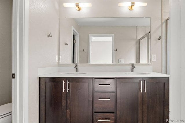 1615 Harlan St Unit 2, Lakewood, CO 80214 - bathroom with double vanity, toilet, baseboard heating, and a stall shower