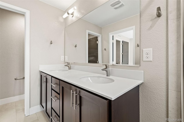 1615 Harlan St Unit 2, Lakewood, CO 80214 - full bathroom featuring tile patterned floors, double vanity, and baseboards