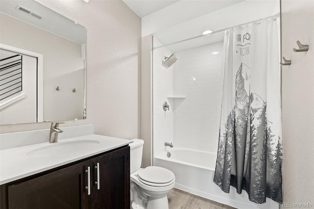 1615 Harlan St Unit 2, Lakewood, CO 80214 - full bath featuring toilet, wood finished floors, vanity, and shower / bath combo with shower curtain