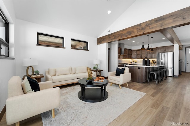 living area with beamed ceiling, recessed lighting, light wood finished floors, and high vaulted ceiling