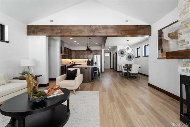 living area featuring recessed lighting, baseboards, light wood-style floors, and high vaulted ceiling