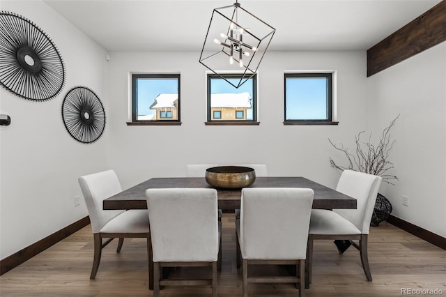 dining space featuring a wealth of natural light, baseboards, and wood finished floors