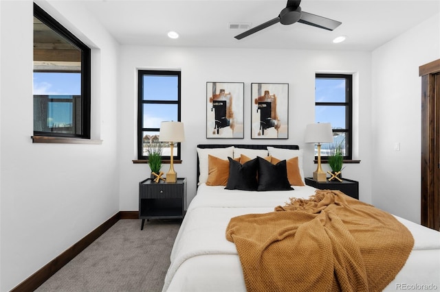 bedroom featuring visible vents, multiple windows, baseboards, and carpet floors