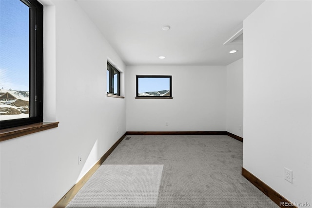 carpeted empty room featuring recessed lighting and baseboards