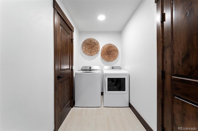 washroom featuring washer and dryer, baseboards, and laundry area