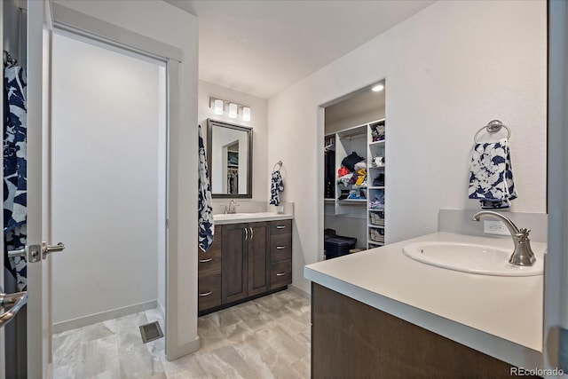 1100 Blue Bell Rd, Berthoud, CO 80513 - full bath featuring two vanities, a spacious closet, and baseboards
