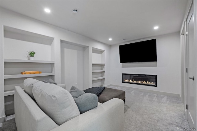 1100 Blue Bell Rd, Berthoud, CO 80513 - living room with built in shelves, carpet floors, a glass covered fireplace, recessed lighting, and baseboards