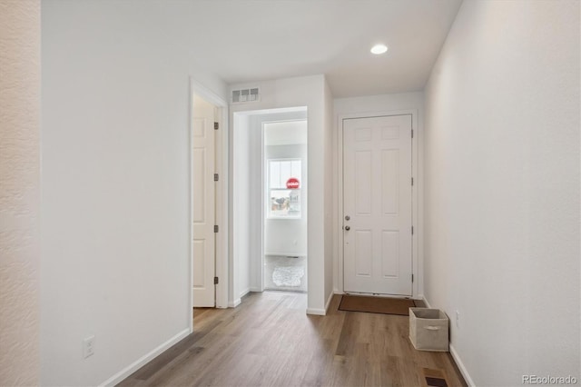 corridor with light hardwood / wood-style flooring