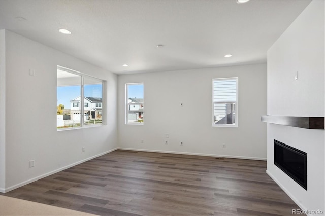 unfurnished living room featuring dark hardwood / wood-style floors