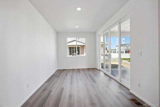 empty room with light hardwood / wood-style floors