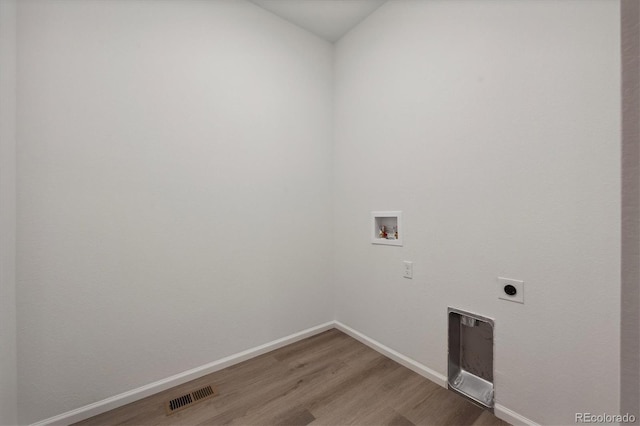 laundry area with hardwood / wood-style floors, electric dryer hookup, and hookup for a washing machine