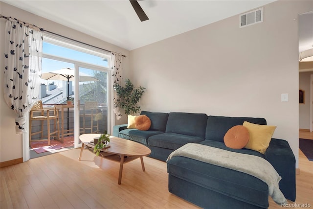 8500 E Jefferson Ave Unit 11C, Denver, CO 80237 - living area featuring light wood finished floors, ceiling fan, and baseboards