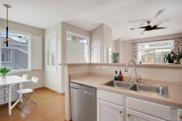 8500 E Jefferson Ave Unit 11C, Denver, CO 80237 - kitchen featuring stainless steel dishwasher, a sink, light wood-style floors, white cabinetry, and decorative light fixtures