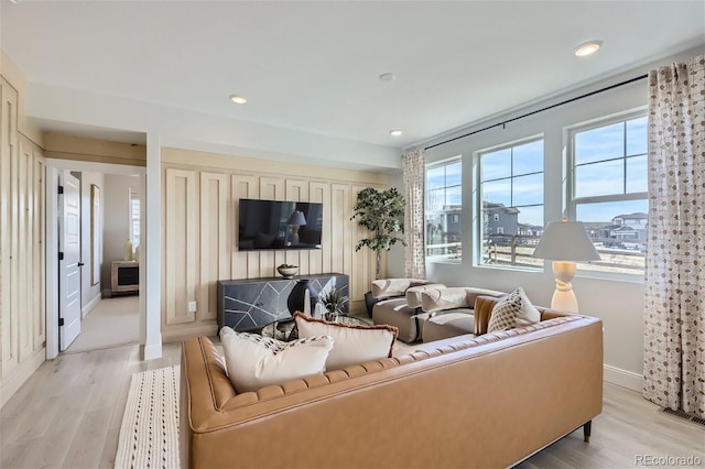 living room with light wood-type flooring, baseboards, and recessed lighting