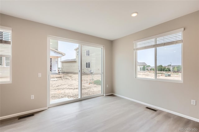 4102 Estrella St, Brighton, CO 80601 - unfurnished room with wood finished floors, plenty of natural light, and recessed lighting