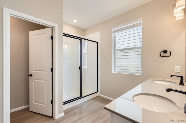 4102 Estrella St, Brighton, CO 80601 - full bath with wood finished floors, a stall shower, and double vanity