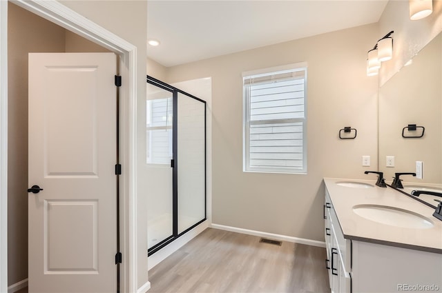 4102 Estrella St, Brighton, CO 80601 - full bathroom featuring wood finished floors, a stall shower, and double vanity
