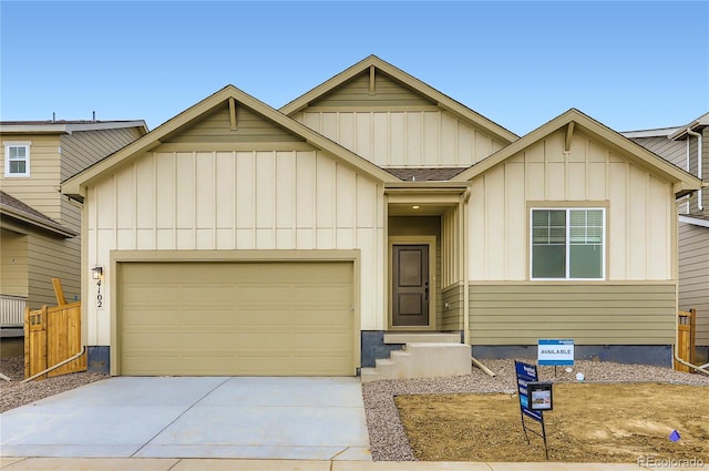 4102 Estrella St, Brighton, CO 80601 - view of front of home with board and batten siding, concrete driveway, an attached garage, and roof with shingles
