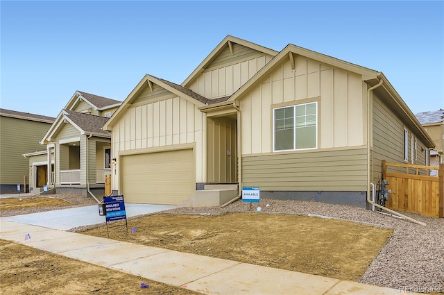 4102 Estrella St, Brighton, CO 80601 - view of front of home with board and batten siding, driveway, an attached garage, and a porch