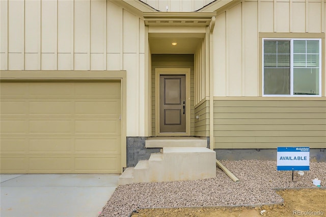 4102 Estrella St, Brighton, CO 80601 - property entrance featuring board and batten siding, a garage, and driveway