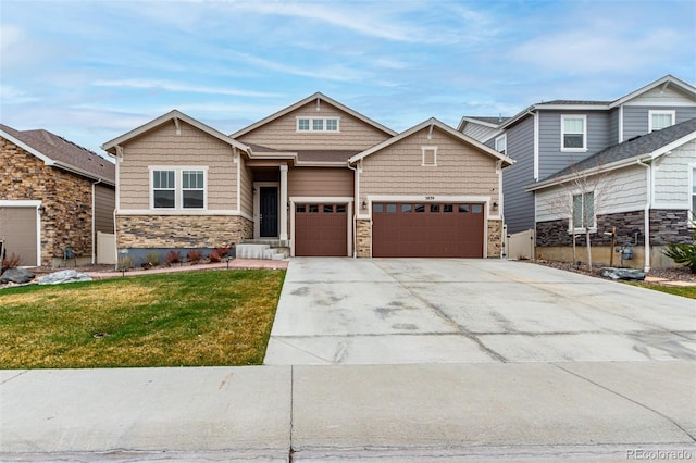 craftsman-style home featuring concrete driveway, a front lawn, stone siding, and a garage