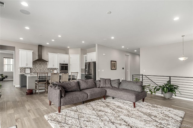 living room featuring visible vents, recessed lighting, and light wood-style floors