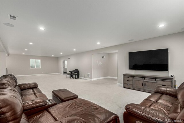 living room with recessed lighting, visible vents, baseboards, and light carpet