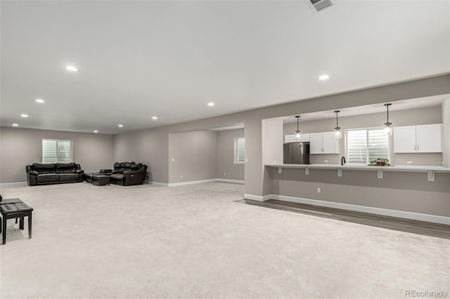 carpeted living room featuring recessed lighting, a wealth of natural light, and baseboards