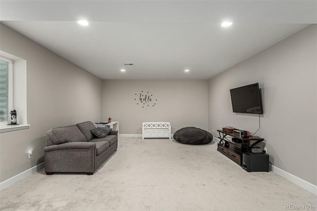 living area featuring carpet floors, visible vents, and recessed lighting