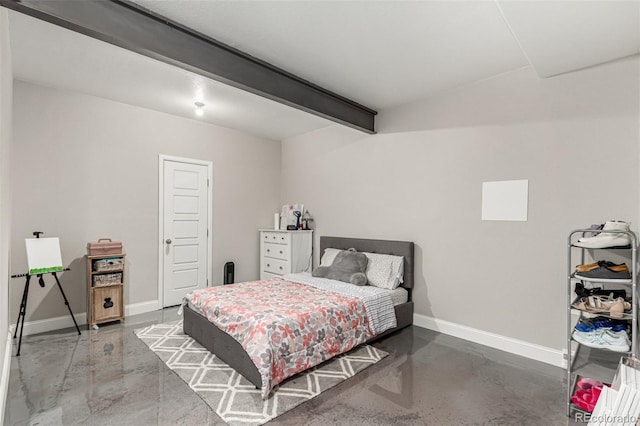 bedroom featuring baseboards, beamed ceiling, and finished concrete flooring