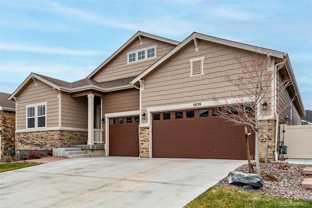 5839 Hay Market Trl, Parker, CO 80134 - craftsman house with stone siding, an attached garage, concrete driveway, and fence