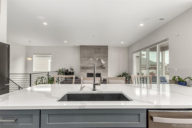 5839 Hay Market Trl, Parker, CO 80134 - kitchen with gray cabinets, stainless steel dishwasher, a sink, recessed lighting, and light stone counters