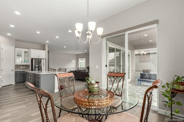 5839 Hay Market Trl, Parker, CO 80134 - dining space featuring light wood-type flooring, recessed lighting, a chandelier, and baseboards