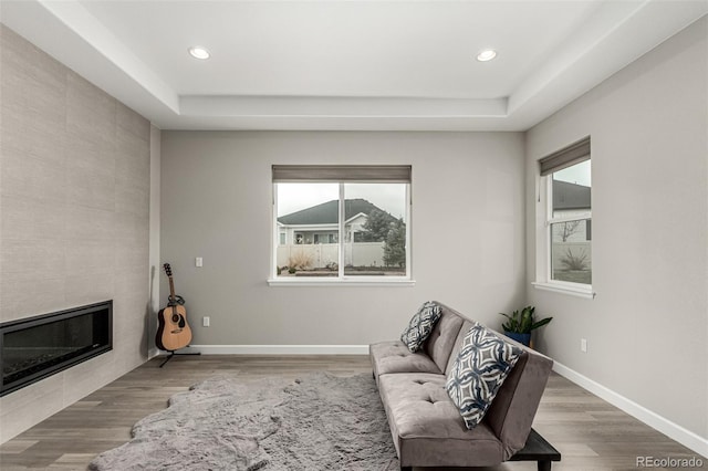 5839 Hay Market Trl, Parker, CO 80134 - living area featuring plenty of natural light, a tiled fireplace, recessed lighting, and wood finished floors