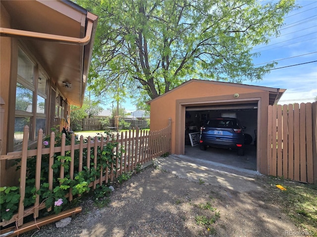 7371 Granada Rd, Denver, CO 80221 - view of home's exterior with driveway, a garage, and an outbuilding