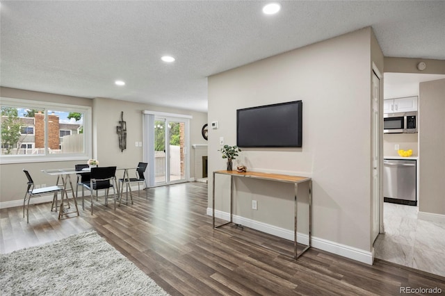 2856 S Kenton Ct, Aurora, CO 80014 - living area featuring recessed lighting, wood finished floors, and a textured ceiling