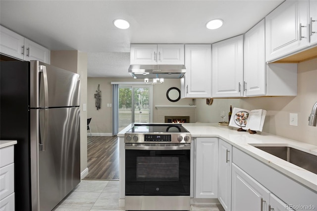 2856 S Kenton Ct, Aurora, CO 80014 - kitchen featuring appliances with stainless steel finishes, under cabinet range hood, and white cabinetry