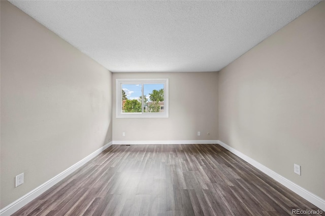 2856 S Kenton Ct, Aurora, CO 80014 - empty room with dark wood finished floors and a textured ceiling