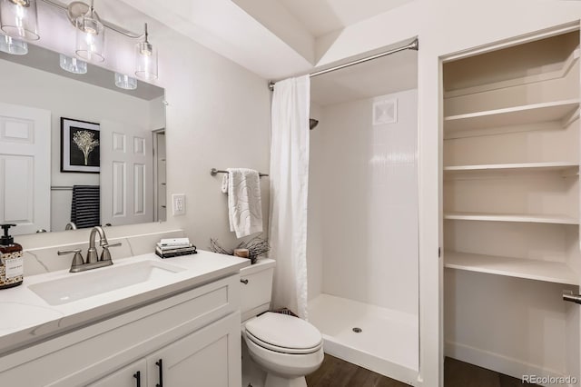 610 S Clinton St Unit 5A, Denver, CO 80247 - full bathroom with a stall shower, vanity, and wood finished floors