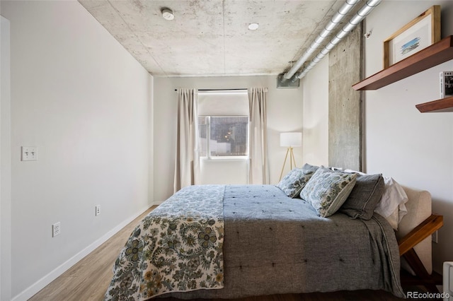 1475 Delgany St Unit 307, Denver, CO 80202 - bedroom featuring wood finished floors and baseboards