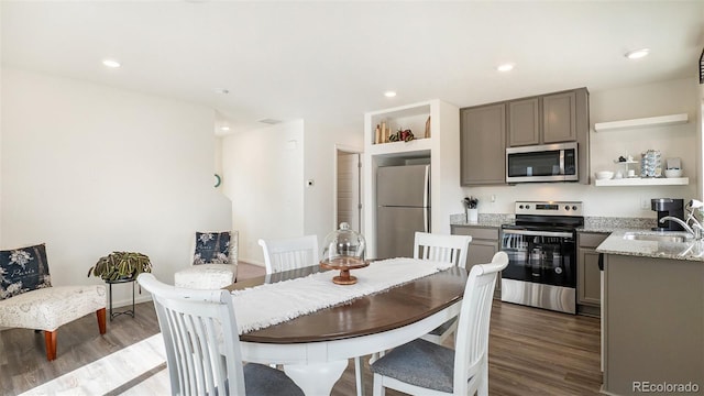 dining space with recessed lighting, baseboards, and wood finished floors