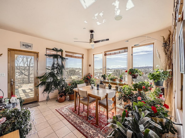 sunroom / solarium with a ceiling fan